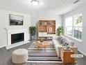 Bright living room featuring a cozy fireplace, stylish furniture, and large window for natural light at 7007 Setters Way, Lithonia, GA 30038