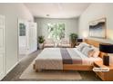 Serene bedroom with ample natural light, neutral tones, and a view to the bathroom at 7007 Setters Way, Lithonia, GA 30038
