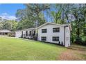 Charming renovated home with a freshly painted white brick exterior, black trim, and an inviting front porch at 106 Hickory Ave, Fayetteville, GA 30215