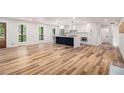 Bright open-concept living area features hardwood floors, white walls, and a stylish black kitchen island at 106 Hickory Ave, Fayetteville, GA 30215