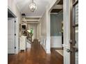Bright entryway with hardwood floors, white trim, and a view of the staircase at 4415 Saint Andrews Crest Dr, Cumming, GA 30040