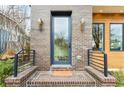 Charming front door framed by brick, modern sconces and a small porch enhancing curb appeal at 522 Boulevard Ne Pl, Atlanta, GA 30308