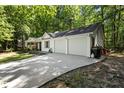 View of the home with a long driveway and a two-car garage at 121 Danielle Ct, Villa Rica, GA 30180