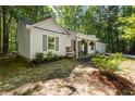 Well-maintained single-Gathering home with white siding and a cozy covered porch in a wooded setting at 121 Danielle Ct, Villa Rica, GA 30180