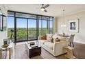 Inviting living room with large windows, stylish furniture, and a view of lush greenery at 2233 Peachtree Ne Rd # 903, Atlanta, GA 30309