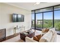 Open-concept living room featuring floor-to-ceiling windows and a neutral color palette at 2233 Peachtree Ne Rd # 903, Atlanta, GA 30309