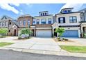 Attractive townhomes show individual design and attached garages with manicured landscaping at 240 Walker Avenue, Roswell, GA 30076