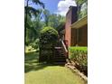 Backyard view featuring a wooden deck with steps leading down to the lawn at 9278 Seminole Rd, Jonesboro, GA 30236