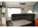 Spacious living room featuring a large sectional sofa and modern ceiling fan at 1425 Watercrest Cir, Lawrenceville, GA 30043