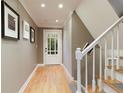 Inviting foyer with hardwood floors, staircase, and a door with glass panes at 220 N Springs Ct, Sandy Springs, GA 30328