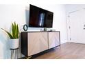 Stylish cabinet with decorative accents and a mounted flat screen TV at 3273 Elm St, Atlanta, GA 30337
