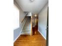 Inviting entryway with hardwood floors, staircase, and natural light at 790 Village Field Ct, Suwanee, GA 30024