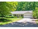 Quaint single-story home with a covered front porch, attached garage, and an expanse of green lawn at 1294 Red Rock Rd, Acworth, GA 30101