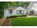 Charming white home featuring a manicured front yard, grey shutters and window boxes at 2316 Hurst Ne Dr, Atlanta, GA 30305