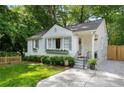 Charming white home featuring a manicured front yard, grey shutters and window boxes at 2316 Hurst Ne Dr, Atlanta, GA 30305