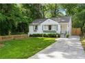 Charming white home featuring a manicured front yard, grey shutters and window boxes at 2316 Hurst Ne Dr, Atlanta, GA 30305