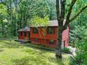 Attractive exterior view of home nestled in a lush, green, wooded environment at 2420 Leaf Land Dr, Duluth, GA 30097