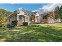 Brick home with an expansive lawn and mature trees, offering curb appeal and a serene outdoor space at 6740 Mountain Lake Ln, Cumming, GA 30028