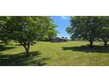 Charming single-story brick home set back on a sprawling green lawn, framed by mature trees at 14721 Highway 36, Covington, GA 30014
