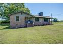 Charming brick home with a neatly manicured lawn and blooming flowerbeds, offering a warm and inviting curb appeal at 14721 Highway 36, Covington, GA 30014