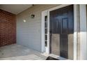 Welcoming front door with sidelight window, modern lock and brick accents providing a secure and stylish entrance at 2114 Woodland Ln, Alpharetta, GA 30009