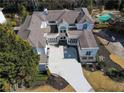 Aerial view of a modern home with a large driveway and a swimming pool at 255 Northland Ridge Trl, Atlanta, GA 30342