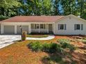 Inviting single-story home with a cozy front porch and a well-maintained yard at 3766 Windy Hill Se Dr, Conyers, GA 30013