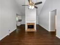 Spacious living room featuring a brick fireplace, vaulted ceilings, and sleek hardwood floors at 3766 Windy Hill Se Dr, Conyers, GA 30013