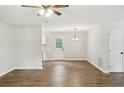 Open-concept living room with hardwood floors, fan, and a bright open floor plan at 100 Davis Mill N Rd, Dallas, GA 30157