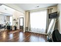 Bright living room with hardwood floors, large window, and neutral paint colors at 2496 Osceola Rd, Lithonia, GA 30058