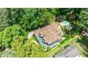 Aerial view of a home with a private pool, lush greenery, and a long driveway at 3117 W Roxboro Ne Rd, Atlanta, GA 30324