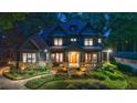 Stately home with well-manicured lawn and landscaping, covered porch, and elegant architectural details at 3117 W Roxboro Ne Rd, Atlanta, GA 30324