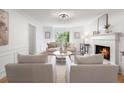 Serene living room with a cozy fireplace, natural light, and tasteful decor, creating a peaceful and welcoming ambiance at 3214 Woodleaf Ct, Marietta, GA 30062