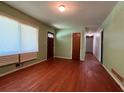 Cozy living room featuring hardwood floors, neutral green walls and a large window at 4048 Emerald Lake Dr, Decatur, GA 30035