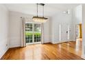 Elegant dining room with hardwood floors, a large window, and a stunning chandelier at 610 Golden Meadows Ln, Suwanee, GA 30024