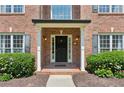 Inviting brick front porch with columns and black front door at 610 Golden Meadows Ln, Suwanee, GA 30024