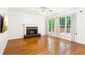 Spacious living room with hardwood floors, a fireplace, and ample natural light at 610 Golden Meadows Ln, Suwanee, GA 30024