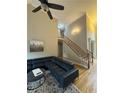 Open-concept living room featuring hardwood floors, staircase, and neutral paint at 1640 Settindown Dr, Roswell, GA 30075