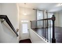 Inviting entryway with dark wood floors, staircase, and natural light from the window at 2464 Georgetown Ave, Atlanta, GA 30345