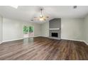 Spacious living room with hardwood floors, gray brick fireplace, fan and sliding door to outside at 2991 Black Bear Se Dr, Marietta, GA 30067