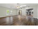 Open-concept living room with hardwood floors, fan, and great natural light, flowing into kitchen at 2991 Black Bear Se Dr, Marietta, GA 30067