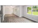 Inviting living space featuring modern gray flooring, fresh white walls, and ample natural light from large windows at 35 Riverbend Dr, Covington, GA 30014