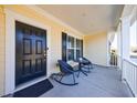 Cozy front porch featuring two chairs and a small table, perfect for relaxing at 807 Parker Pass, Peachtree City, GA 30269