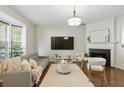 Cozy living room with a large TV and fireplace at 3754 Berkeley Xing, Duluth, GA 30096