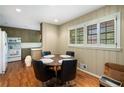Eat-in kitchen features wood floors, a round dining table, and olive green-painted cabinets at 2556 Defoors Ferry Nw Rd, Atlanta, GA 30318