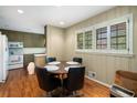 Cozy dining area with hardwood floors, surrounded by natural light streaming through shuttered windows at 2556 Defoors Ferry Nw Rd, Atlanta, GA 30318