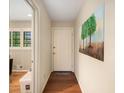 Welcoming hallway with hardwood floors, leading to a bright room with a view, and stylishly decorated with tree art at 2556 Defoors Ferry Nw Rd, Atlanta, GA 30318