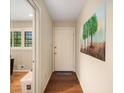 Bright hallway with hardwood floors, an entry door, and decorative wall art at 2559 Defoors Ferry Nw Rd, Atlanta, GA 30318