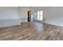 Bright living room with wood-look floors, chair rail molding, neutral paint, and great natural light at 3260 Ridgefair Dr, Cumming, GA 30040