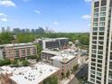 Aerial view of the neighborhood, showing the apartment building in relation to the greenery and Atlanta skyline at 660 Glen Iris Dr # 206 & 109, Atlanta, GA 30308